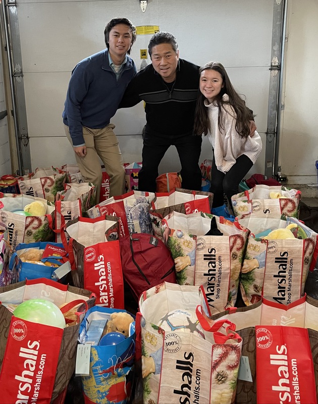 The Lee Family With Donations For 40 Families