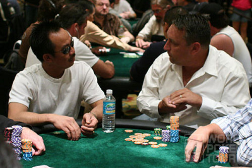 David Pham (left) watches as Bill Edler takes the chip lead with a big pot early on Day 2 of the Gulf Coast Poker Championship.