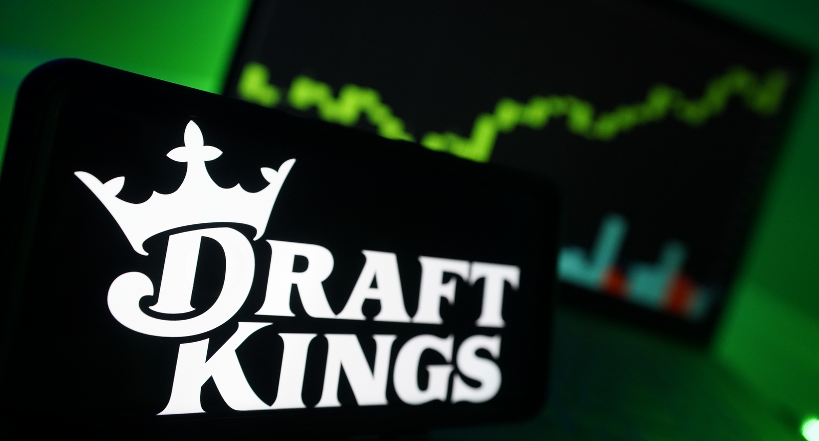 The DraftKings logo in front of a chart