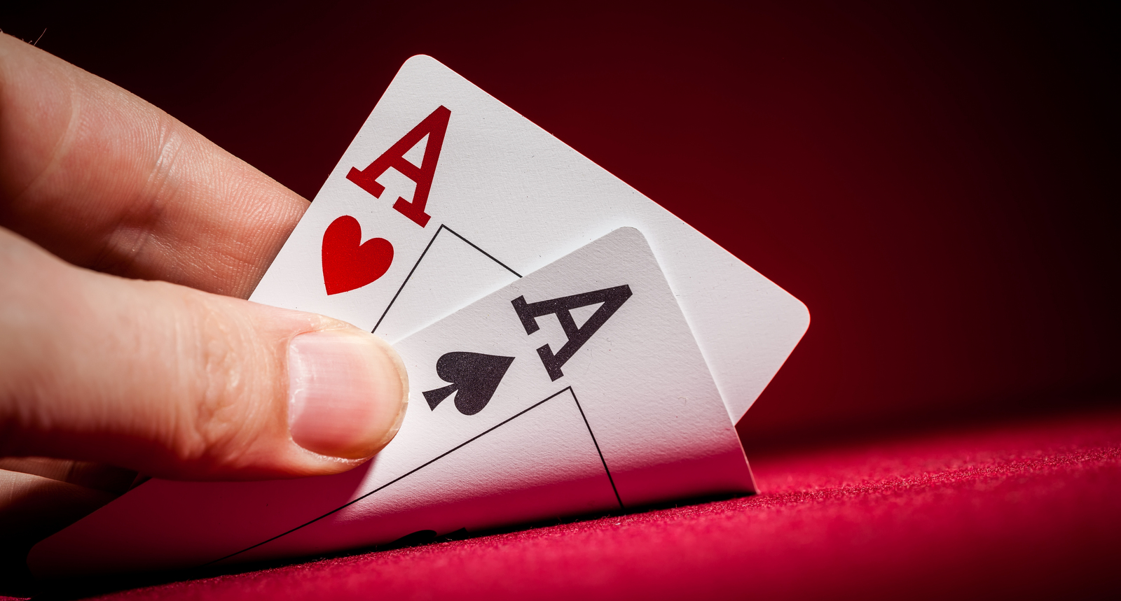 A poker player looking at pocket aces