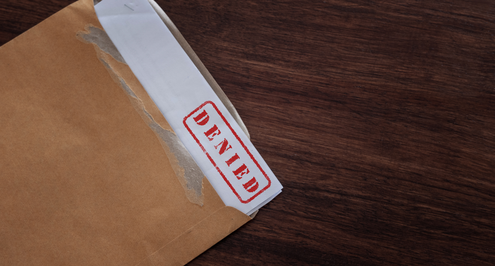 A picture of paperwork with a denied stamp