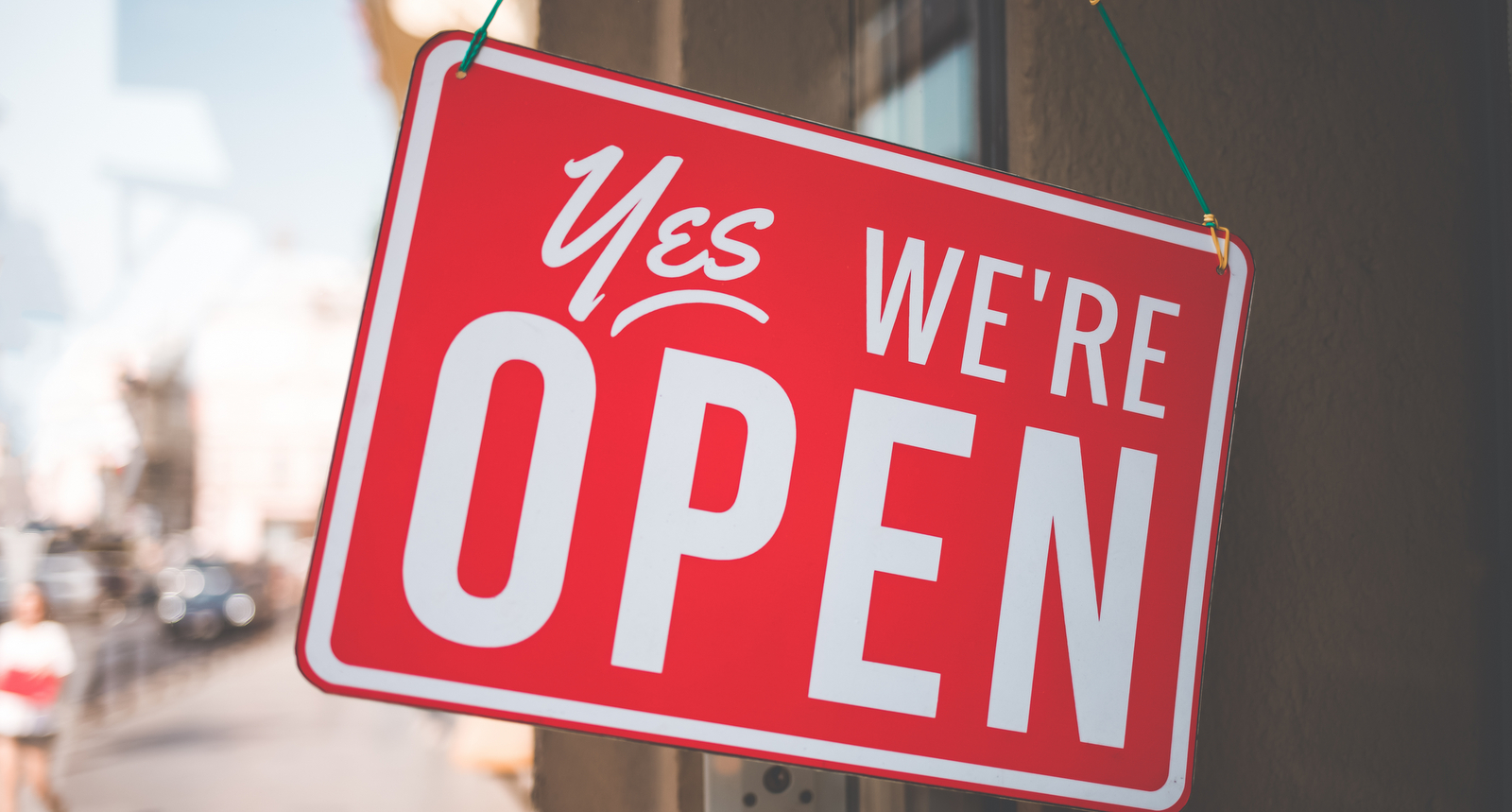 A "Yes, we're open" sign