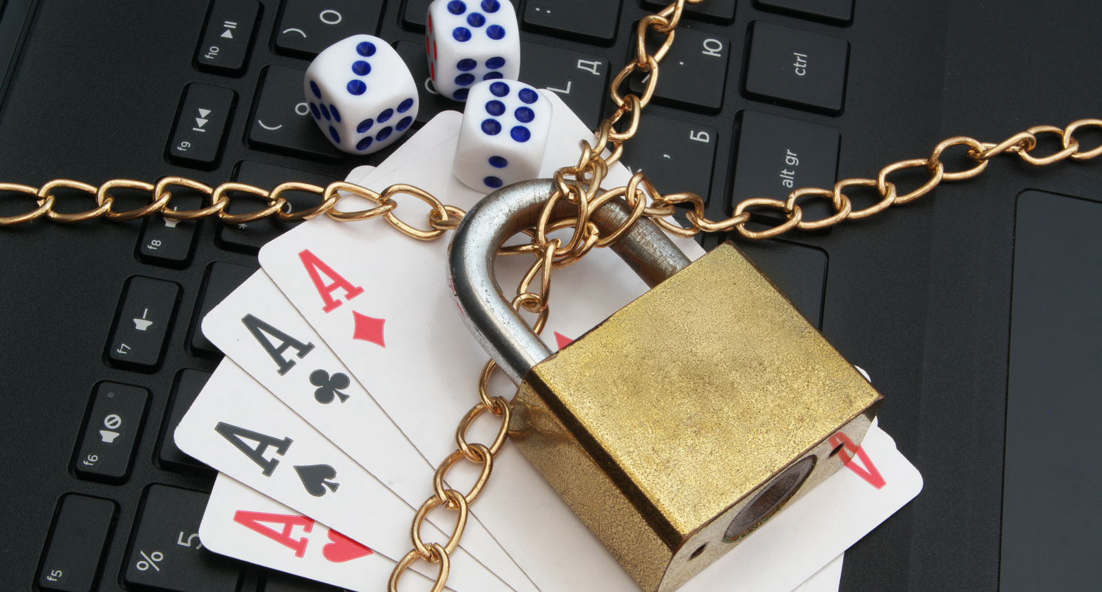 A picture of cards and dice locked on a keyboard
