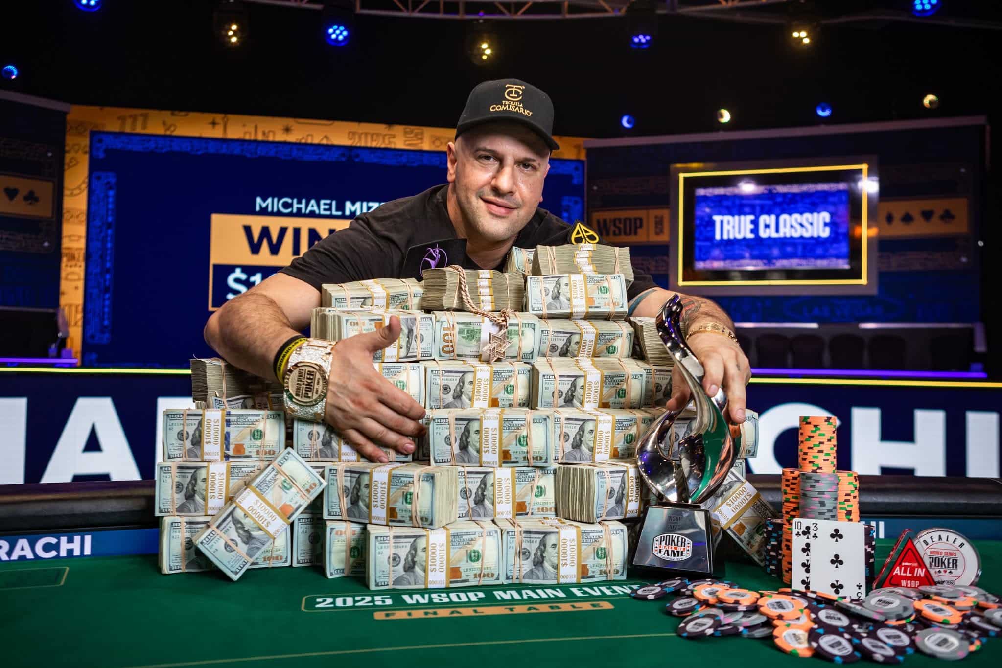Michael Mizrachi with the WSOP Main Event 2025 trophy and stacks of cash