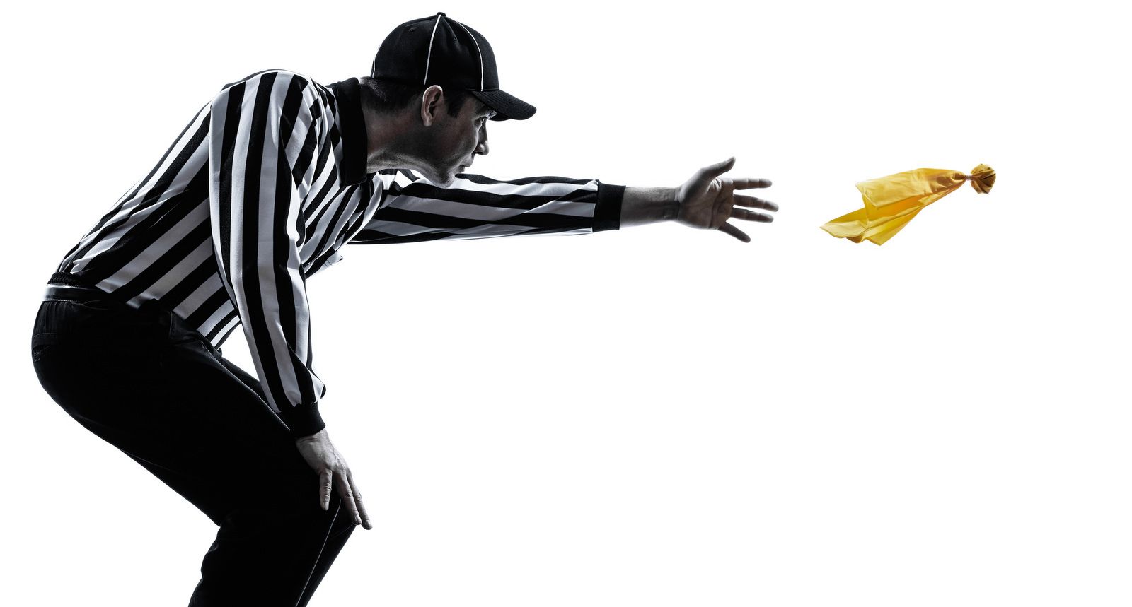 An image of a football referee throwing a penalty flag.