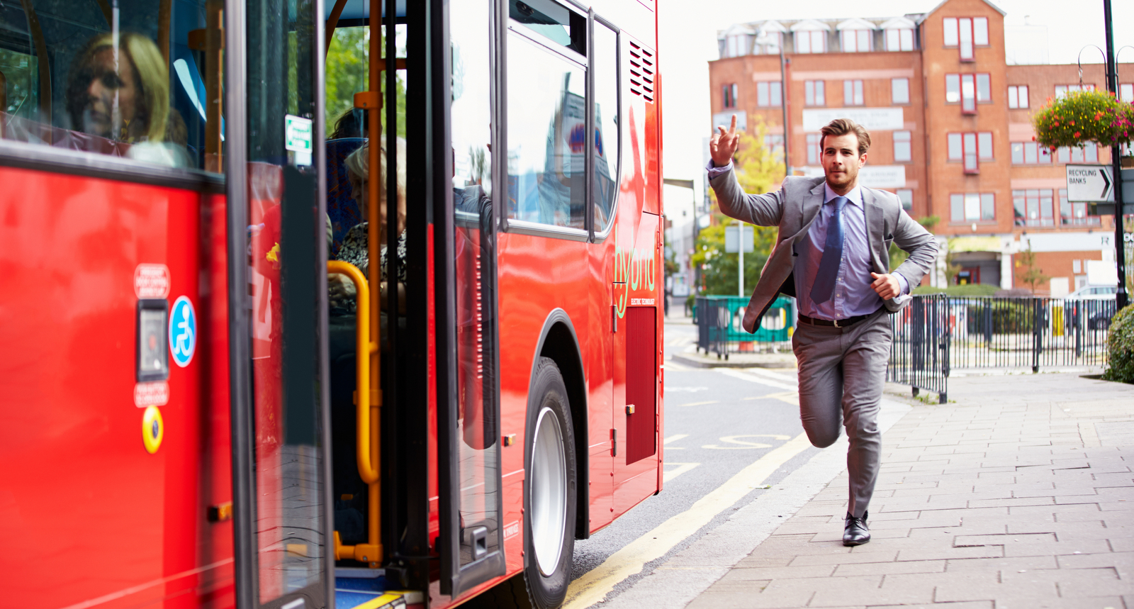 A picture of a businessman running after a bus