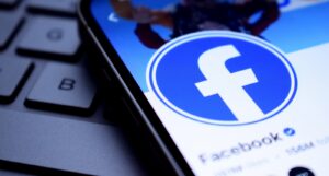 An image of the Facebook logo on a phone