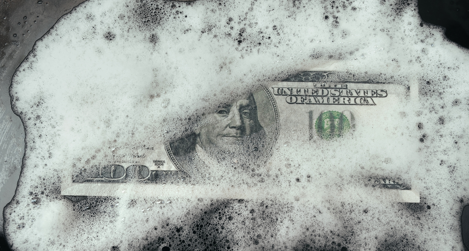 A picture of a $100 bill getting washed