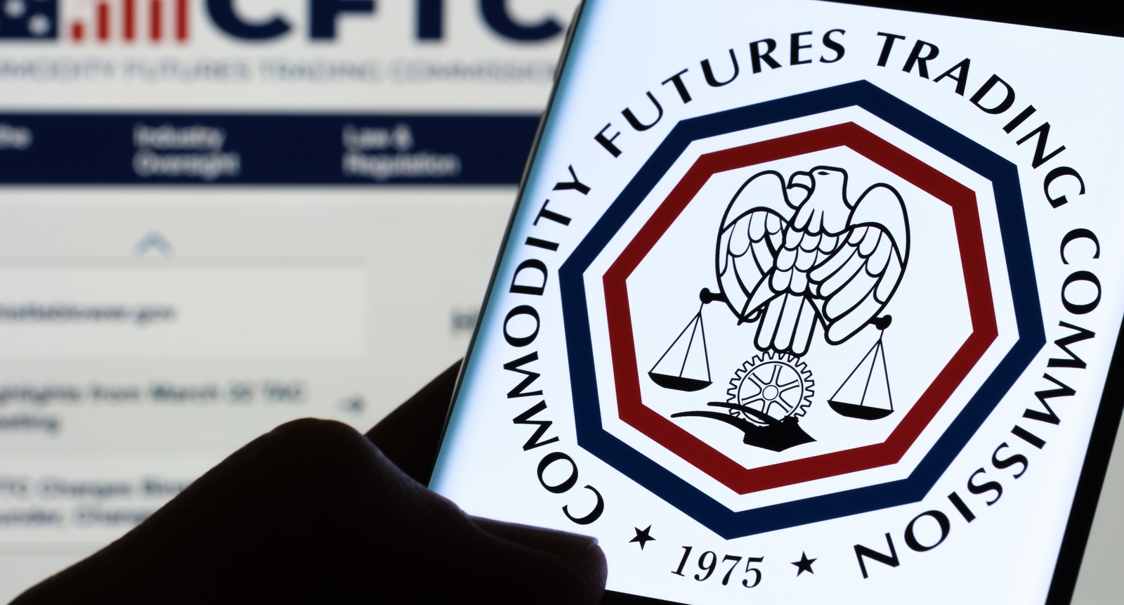 A picture of the CFTC logo on a phone