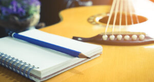 A picture of a notebook on a guitar