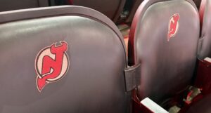 A picture of the New Jersey Devils logo on a stadium seat.