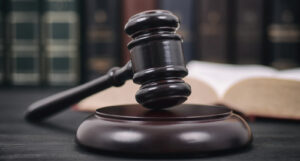A picture of a judge's gavel and a lawbook.