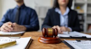 A picture of a judge's gavel with two lawyers