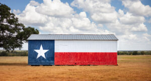 A picture of a barn with the Texas flag painted on it.